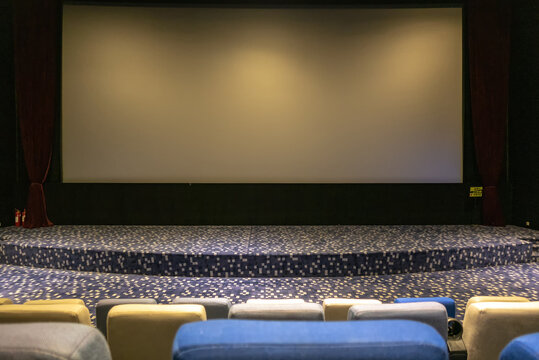 Empty Movie Theater with Arranged Seats and Projection Screen