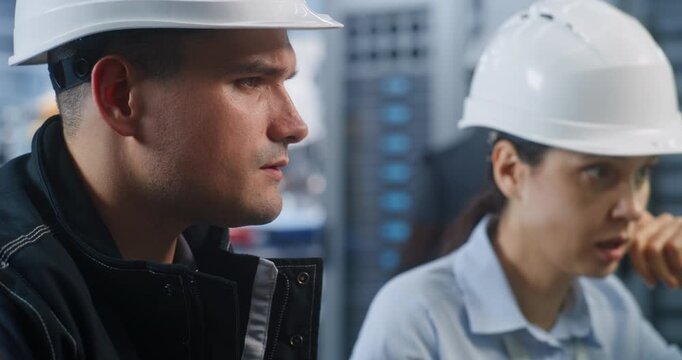 Industrial Engineers Debate Part Tolerances, Measuring Metal Prototype with Vernier Caliper. Team Collaboration and Precision Testing Resolve Technical Problems in Modern Smart Plant Workflows.