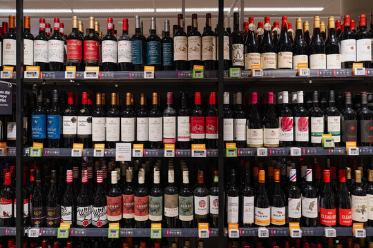 August 20, 2026, Amsterdam, Netherlands - Shelves stocked with various wine bottles in a supermarket