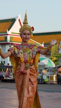 Thai Traditional Dancer Performing in Golden Costume at Wat Suthat Bangkok