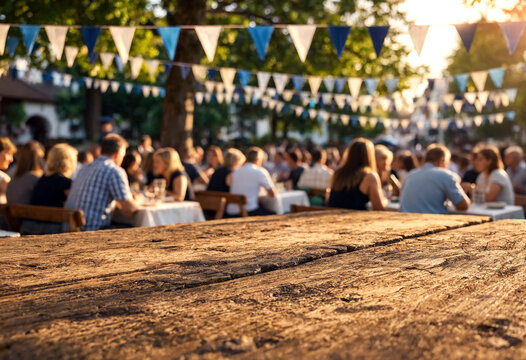 Outdoor festival with people dining together under colorful bunting decorations in a sunny park setting