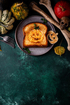 Halloween breakfast toast with cheese and eggs in jack-o-lantern shape