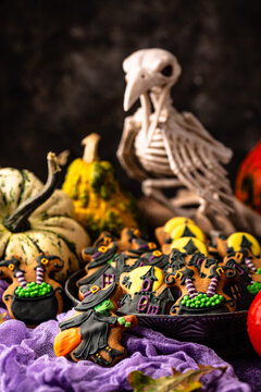 Spooky Halloween cookies shaped like witch cauldron and haunted manor