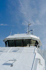 Modern white ferry bridge against a clear blue sky in Norway © heerim studio
