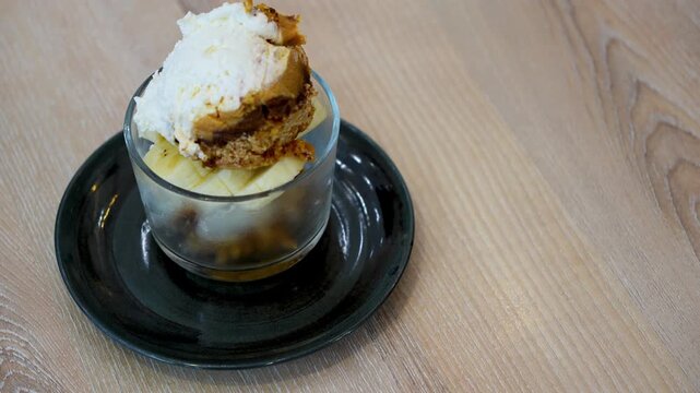 Banoffee with banana and caramel sauce in cafe restaurant