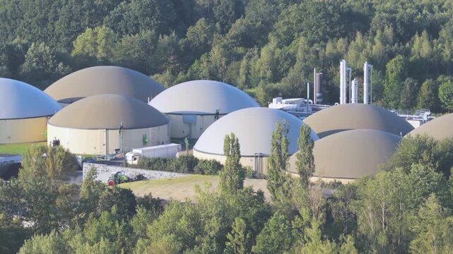 Large Biogas Production Facility with Multiple Digesters and Agricultural Machinery from Above