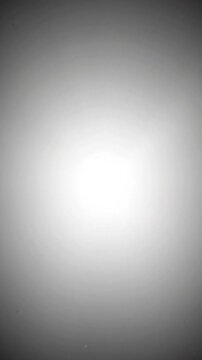 Bright glowing circular light aura effect with soft diffusion rays and ethereal motion particles for cinematic digital video production backgrounds