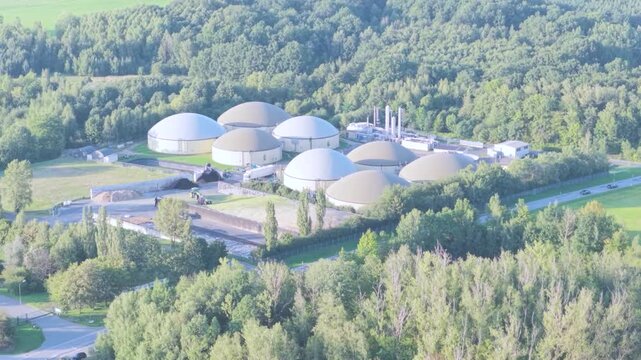 Large Biogas Production Facility with Multiple Digesters and Agricultural Machinery from Above