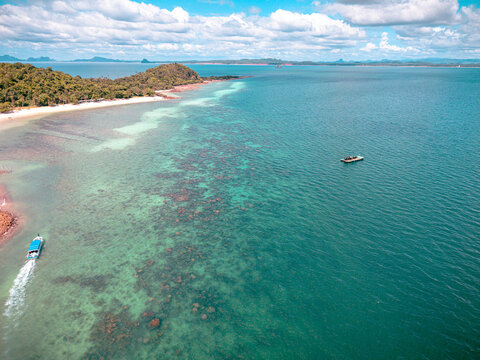 View of the beach and coastline of remote island along with underwater natural hard coral and reef