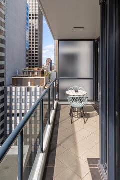 Nondescript view of inner city balcony overlooking inner urban high rise