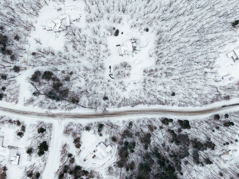 Aerial winter view of Bromont ski resort with snowy slopes, village and parking area in Quebec, Canada. g.