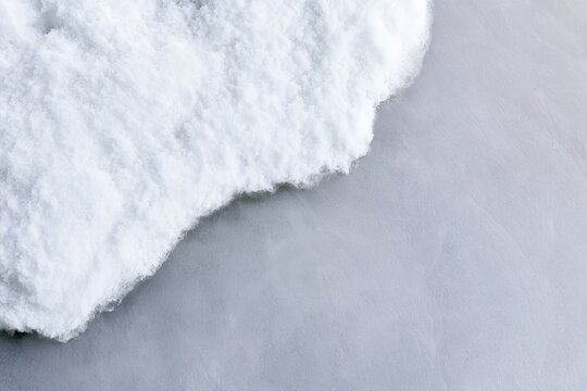 Snow covering a gray surface during winter season in a cold environment