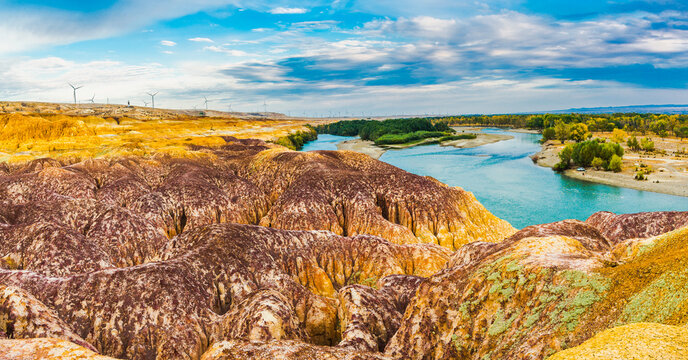 Colorful Beach, also known as Wucaitan, in Burqin County, Altay Prefecture, Xinjiang, China. The scenic landscape features colorful Yardang rock formations along the Irtysh River, surrounded by a




