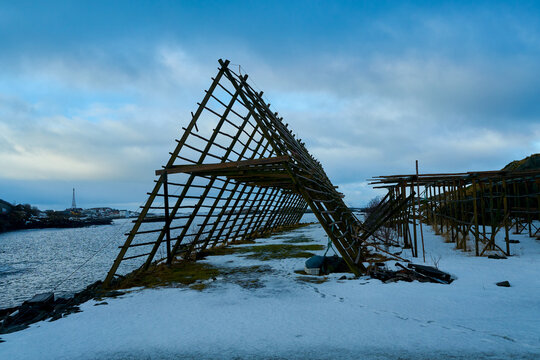 Traditional wooden fish drying racks in winter landscape at A village in Lofoten Norway