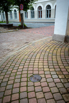 Cobblestone pavement outside historic Kuldiga building