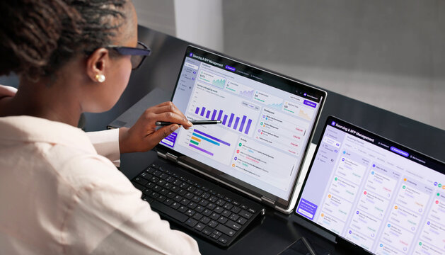 Procurement Manager Reviews Supplier Proposals Carefully Using Laptop