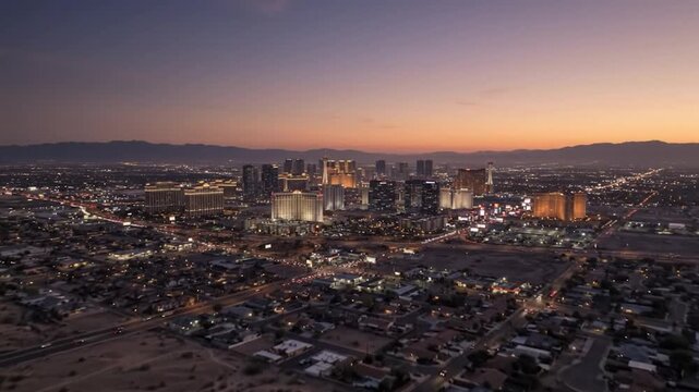 Aerial drone view of las vegas skyline at sunset, cinematic cityscape with glowing lights and desert horizon