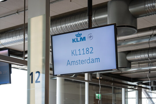 August 19, 2026, Stavanger, Norway - Digital display screen showing KLM flight KL1182 to Amsterdam at an airport gate.