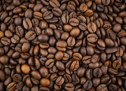 Roasted coffee beans texture background full frame top view.