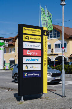 August 19, 2026, Tananger, Norway - Signpost for Tananger Service Senter listing various services including car wash, EV charging, and postal services