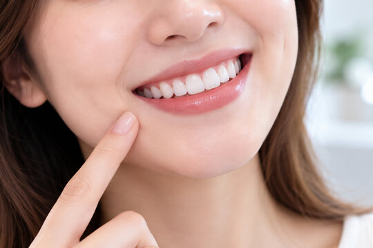 Close up of Asian woman smiling with bright white healthy teeth