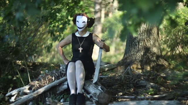 Creepy character with saw for Halloween in spooky forest