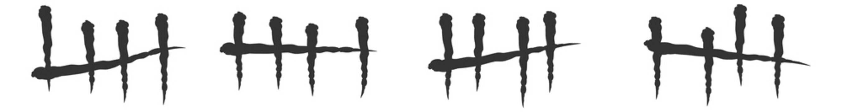 Black tally sticks. Prison wall marks count
