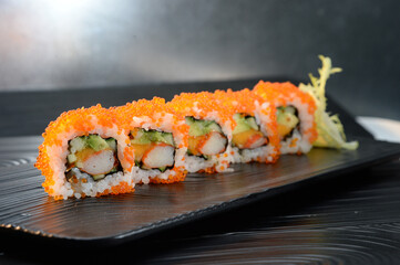 California Roll Sushi with Tobiko on Black Plate © NgoVan