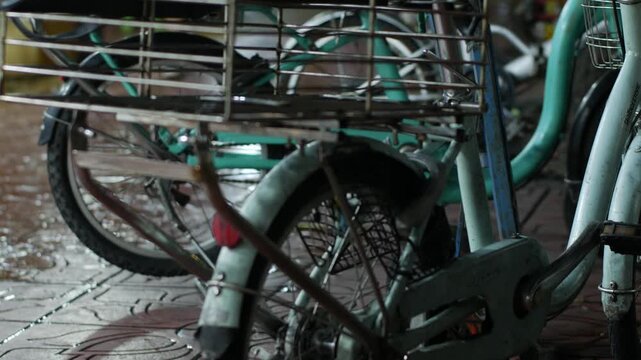 Close-up of bicycle wire basket with parked bikes in background