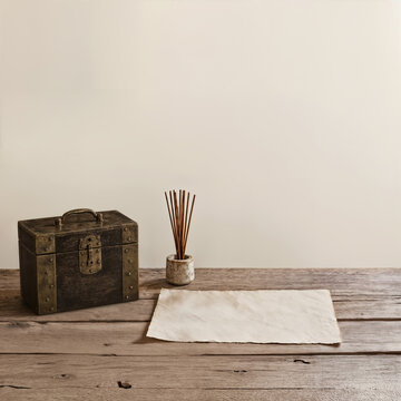 Minimalist Still Life with Antique Box, Incense and Blank Paper on Rustic Table