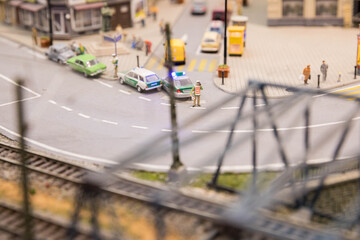Miniature city street with police cars and railway tracks © PhamHong