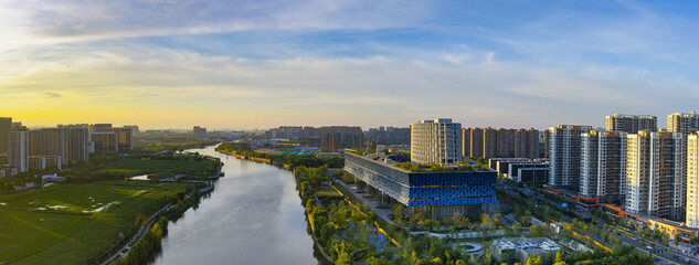 Sunset View of Hangzhou Canal and Modern City Skyline © TranThi