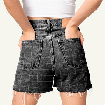 Back view of woman wearing black denim cut off shorts