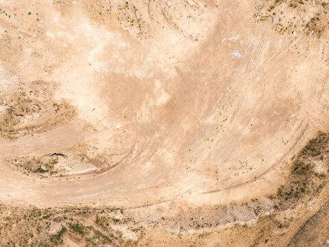 aerial view of off road vehicle drifting in desert sand
