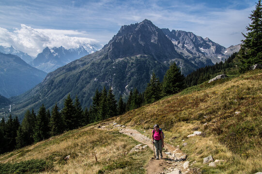 Hiking on a mountain trail with views of peaks and forests