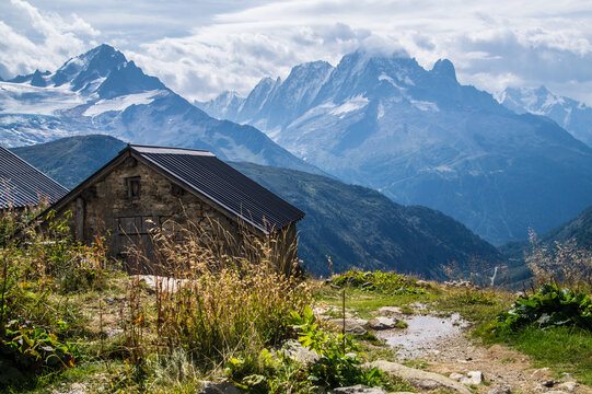 Rustic stone cabin in an alpine mountain landscape