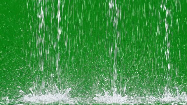 Heavy rain falling against a solid green screen background for easy chroma key compositing