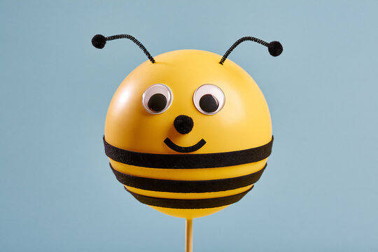 Smiling balloon bumblebee craft character with felt stripes and pipe cleaner antennae