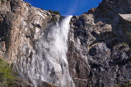 Yosemite Falls waterfall flowing over granite cliffs in California
