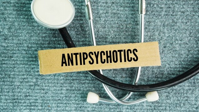 Stethoscope and paper box with word Antipsychotics. prescription medicines used to treat mental health conditions that involve psychosis, such as schizophrenia or bipolar mania.