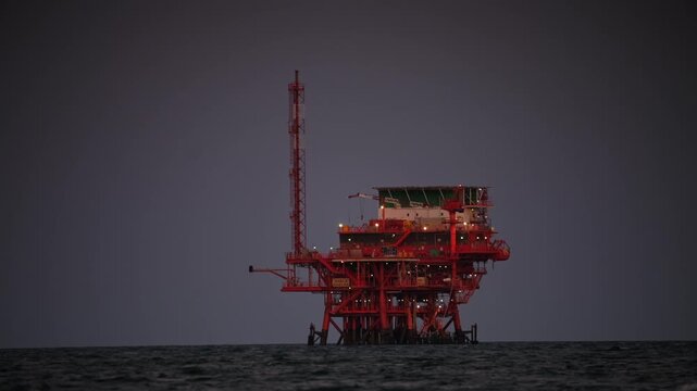 Oil rig at sunset in the ocean