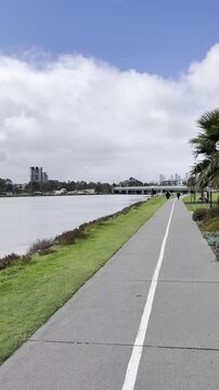 A panoramic view of Melbourne CBD skyscrapers and the slow-flowing Maribyrnong River, seen from Footscray Park, Victoria, Australia.