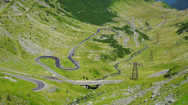 Winding Transfagarasan road and mountain stream seen from above in the Romanian Carpathian Range