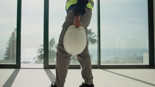 Man, legs and engineer with helmet for walking, safety protocol and compliance regulation for work. Supervisor, hands or hardhat in business for protection, project management or contractor with gear