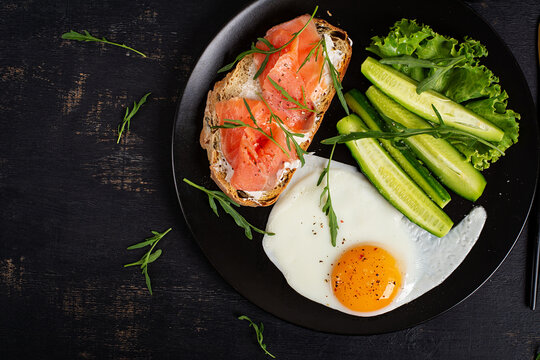 Healthy Breakfast with Smoked Salmon Toast Fried Egg and Fresh Vegetables. Top view