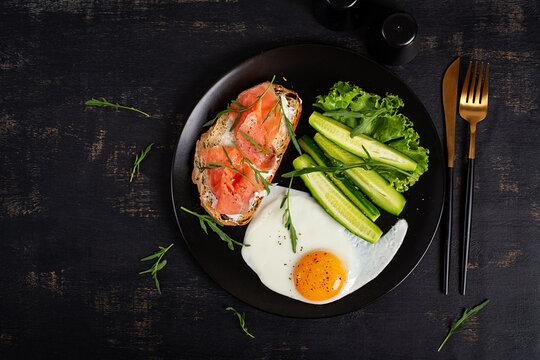 Healthy Breakfast with Smoked Salmon Toast Fried Egg and Fresh Vegetables. Top view
