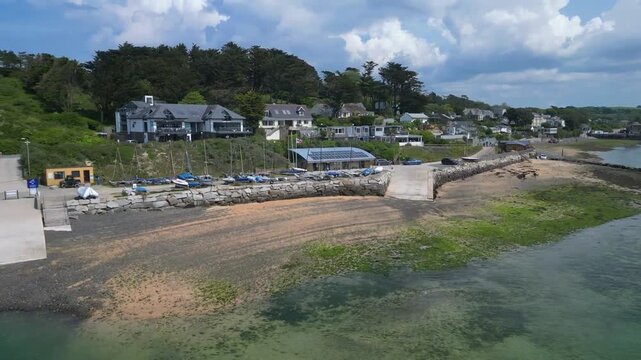 Rock, Cornwall, England: DRONE VIEWS: The drone circles over the River Camel showing the foreshore at Rock including boats and a ramp. Rock is located across the river from the town of Padstow.