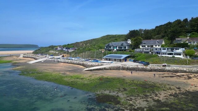 Rock, Cornwall, England: DRONE VIEWS: The drone circles over the River Camel showing the foreshore at Rock including boats and a ramp. Rock is located across the river from the town of Padstow.