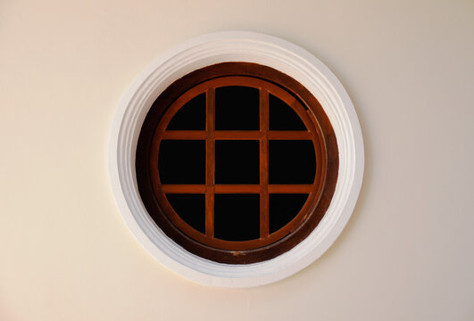 Round and vintage shape of glass window on a brick wall building.