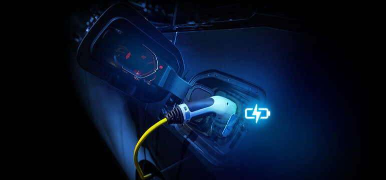 Power cable pump plug in charging power to electric vehicle EV car.